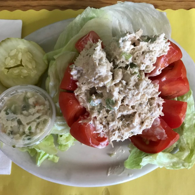 Stuffed tomato on lettuce with tuna salad.