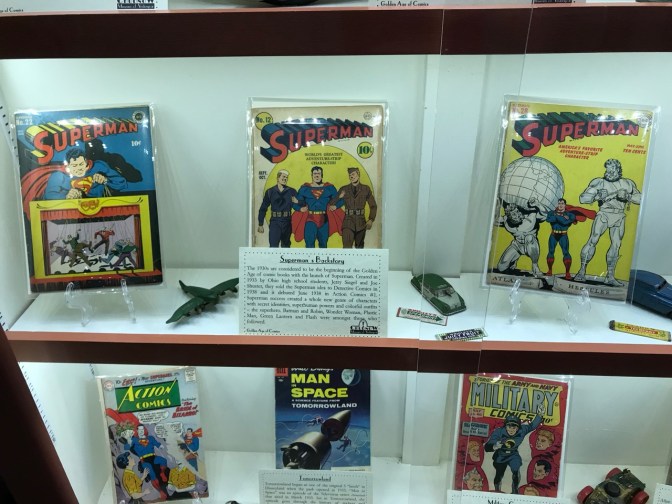 Display of six comic books, including three Superman comic books.