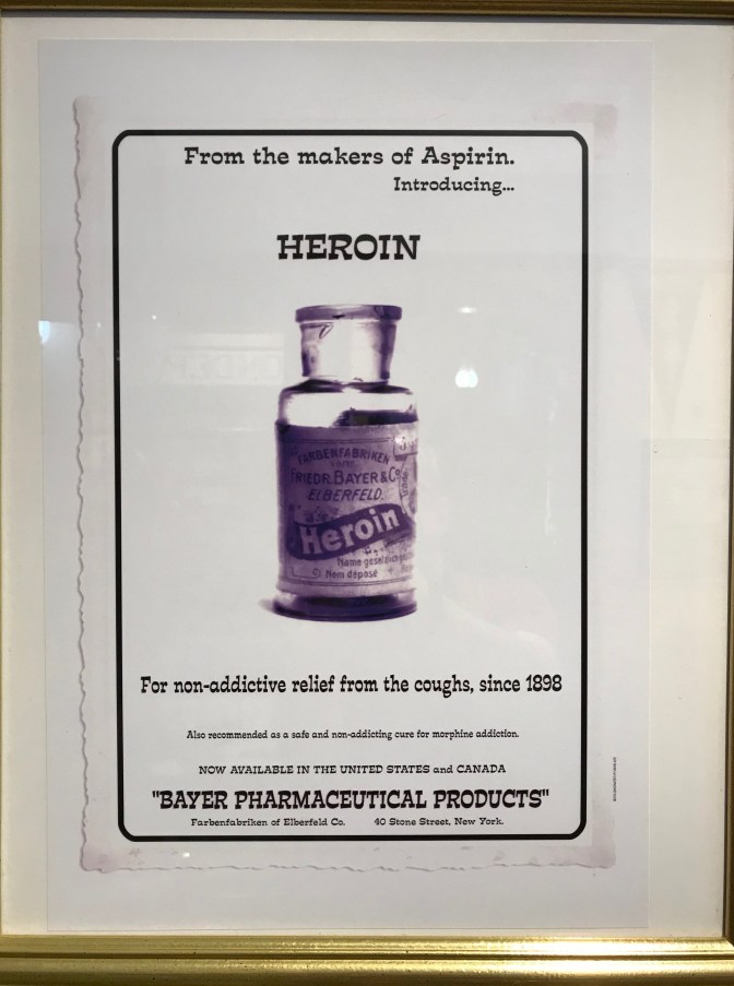 Old ad that says FROM THE MAKERS OF ASPIRIN. INTRODUCING HEROIN. FOR NON-ADDICTIVE RELIEF FROM THE COUGHS SINCE 1898 BAYER PHARMACEUTICAL PRODUCTS