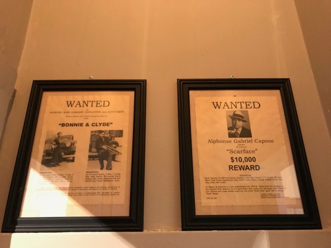 Wanted posters for Bonnie and Clyde and Al Capone.