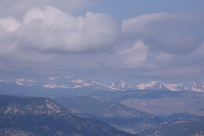 View of Rocky Mountains in the distance beyond the foothills.
