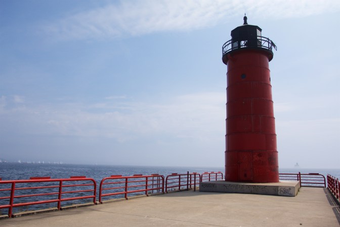 Milwaukee Pierhead Lighthouse, with a red base and black iron top.