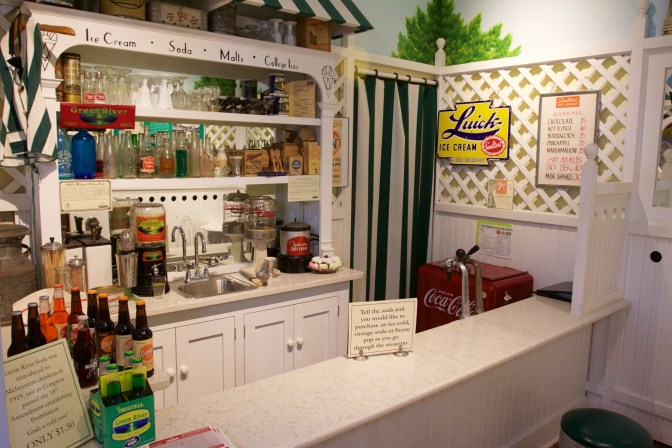 Recreation of a soda fountain from the 1920s, with various bottles and beverages on display.