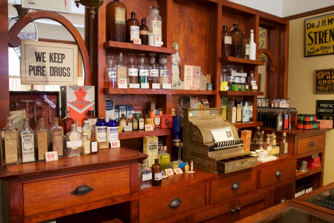 Turn of the century pharmacy counter, with a sign that says WE KEEP PURE DRUGS.