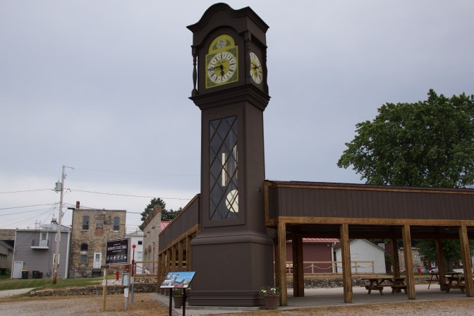 36-foot tall Grandfather Clock, beside a wooden pavilion.