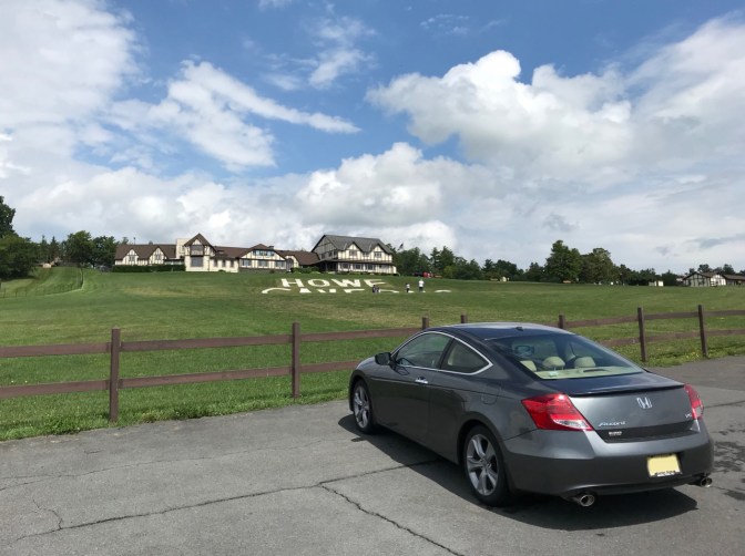 Honda Accord coupe parked in front of Howe Caverns buildings.