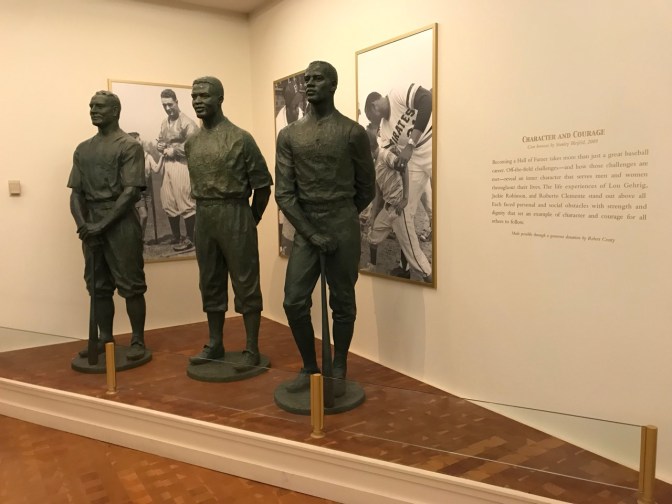 Statues of Lou Gehrig, Jackie Robinson, and Roberto Clemente.