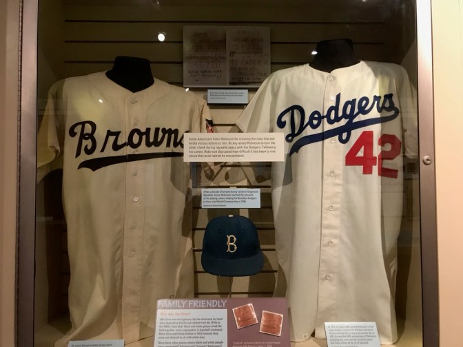 Jerseys of Jackie Robinson, along with his cap.