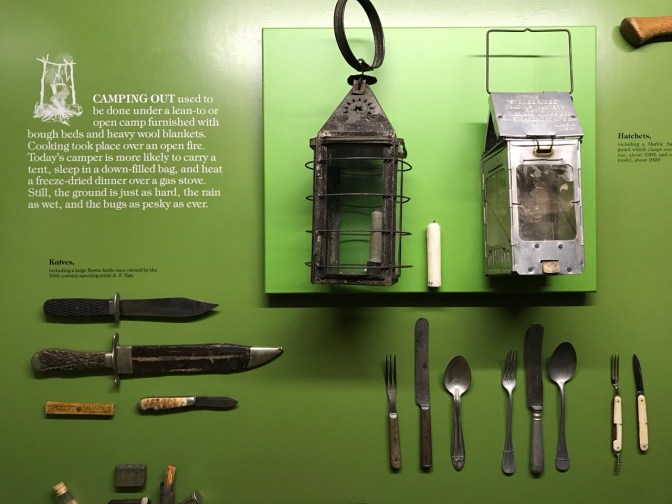 Camping equipment including cutlery, lanterns, and knives.