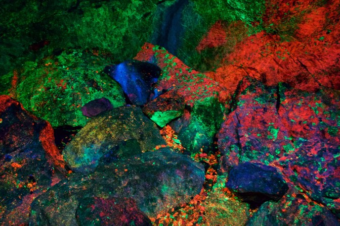 Rocks glowing in fluorescent colors.