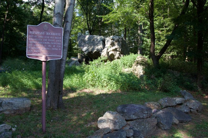 Sign that reads PARSIPPANY ROCKHOUSE. The rock formation is in the background.