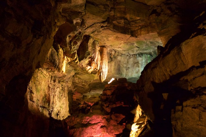 Caves with stalactites hanging from ceiling.