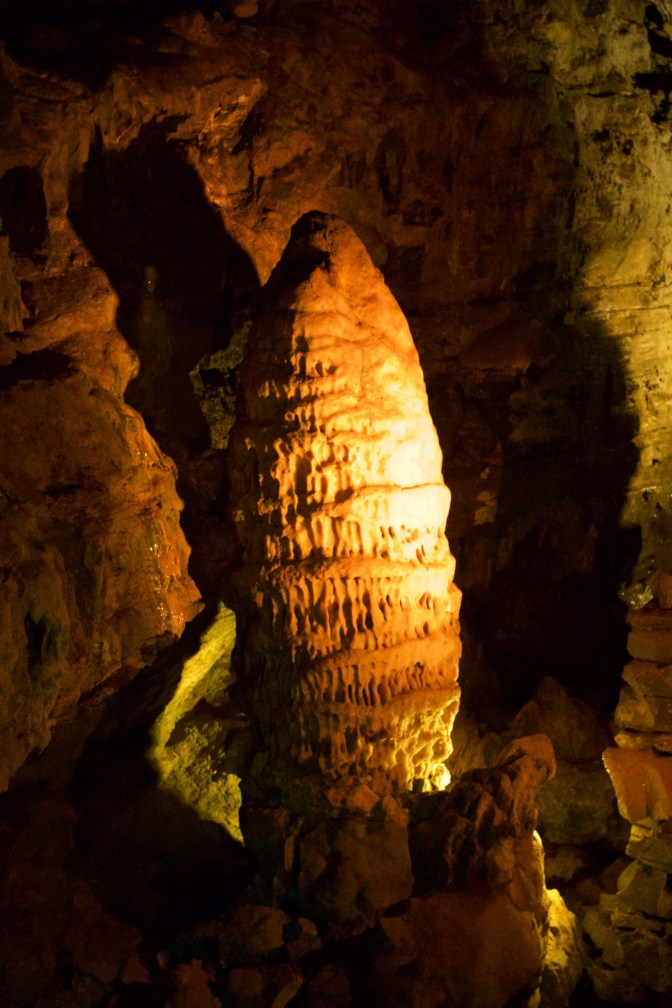 Large stalagmite emerging from floor.