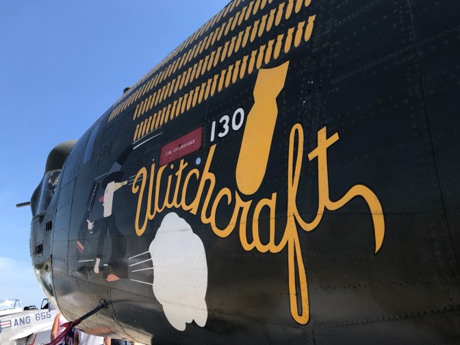 Nose of B-24 with witch flying on a bomb, with the name Witchcraft beside it. 
