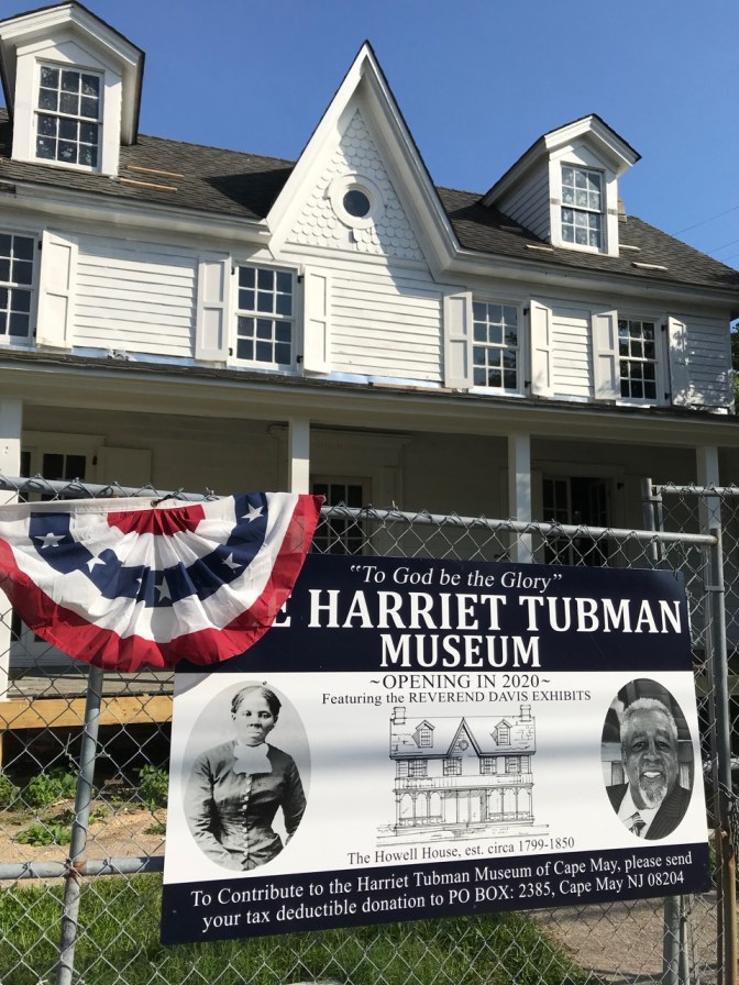 Exterior of white home, with sign in front saying THE HARRIET TUBMAN MUSEUM OPENING IN 2020