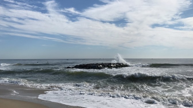 Rough waves against jetty.