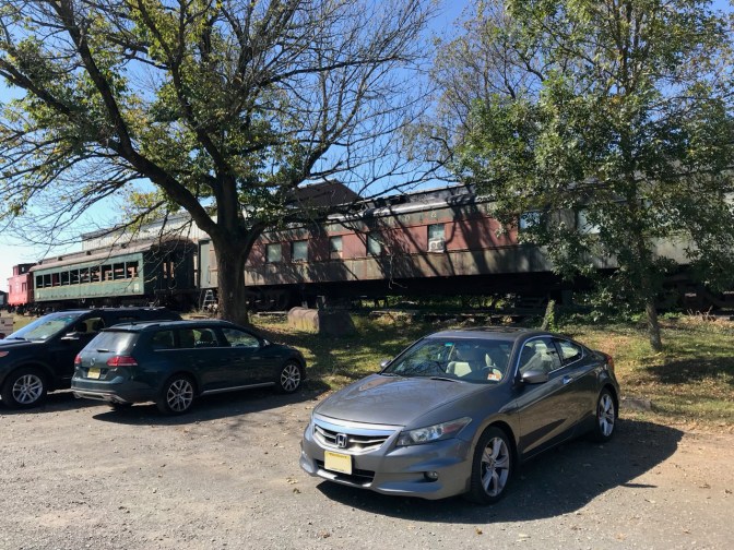 2012 Honda Accord parked in front of railroad cars.