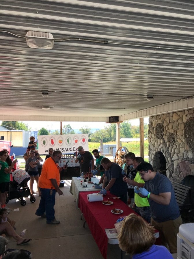 Wing-eating competition under pavilion.