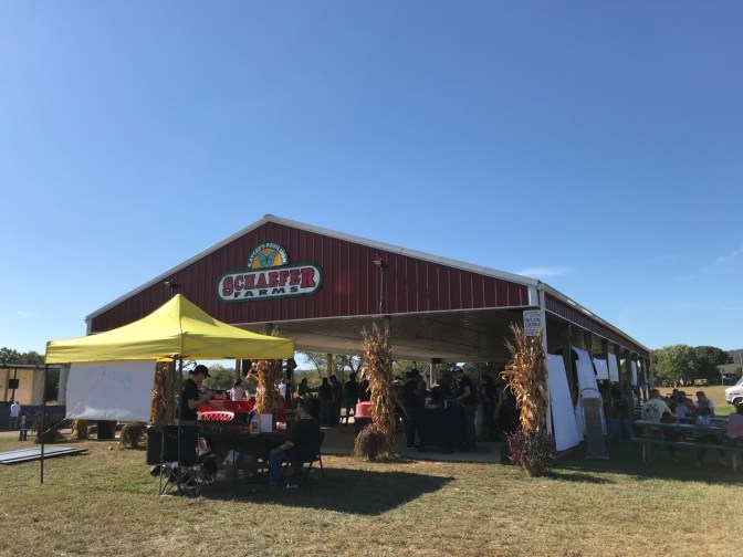Exterior of pavilion at Schaefer Farms, with a yellow tent in the foreground.