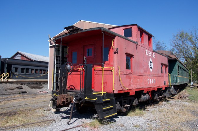 Red caboose at the end of a train.