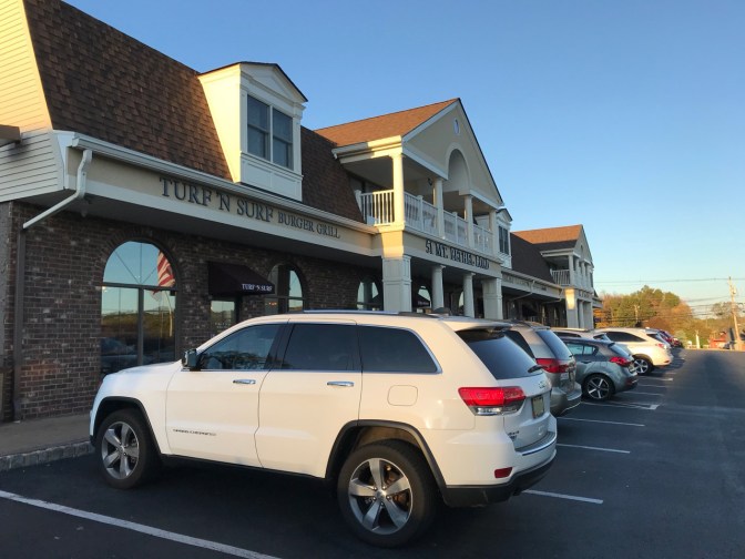 2014 Jeep Grand Cherokee parked in front of Turf N Surf Burger Grill.