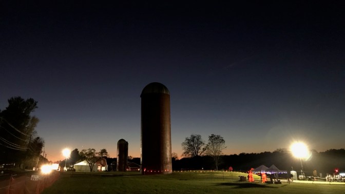 Silos in field at Wagner Farm, with floodlights illuminating the area around it.