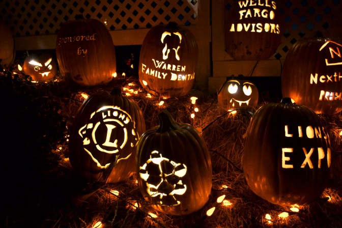 Logos of sponsors carved into pumpkins, including Lions Club, Warren Family Dental, Wells Fargo, and Lions Expo.