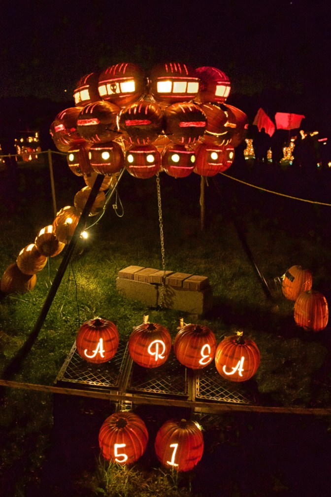 UFO made of pumpkins, with sign on ground (carved into pumpkins) that says AREA 51.