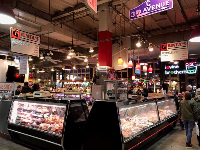 Giunta's Prime Shop butcher market. Blue sign hanging from ceiling says C 3RD AVENUE.