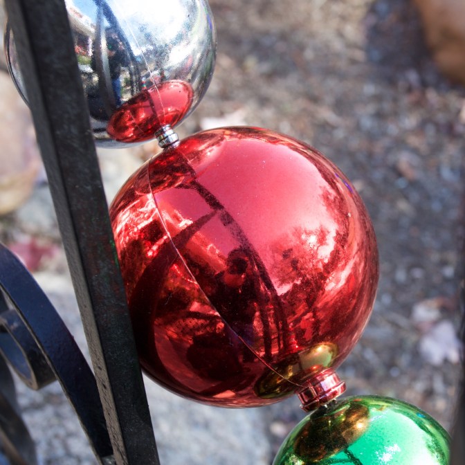 Self-portrait of photographer in Christmas ornaments.