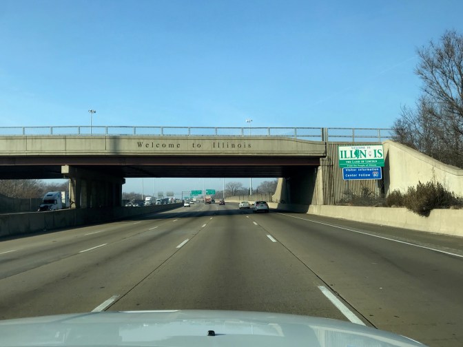 Blue-sky day with bridge that says WELCOME TO ILLINOIS over I-90.