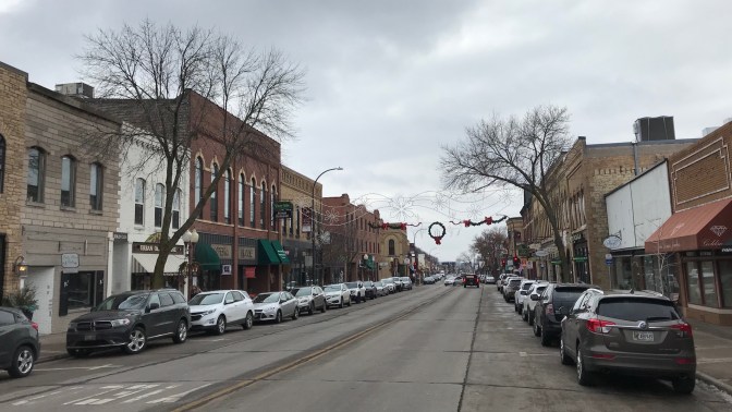 Downtown Hudson, Wisconsin, with brick buildings along both sides of street.