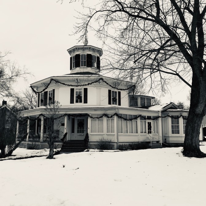 Exterior of octagonal-shaped house. It is two-storied, with a small cupola on the third floor.