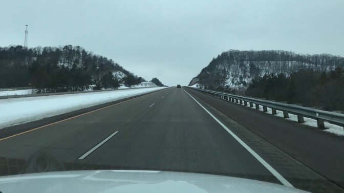 Snow-covered hills along side of I-94 in Wisconsin.