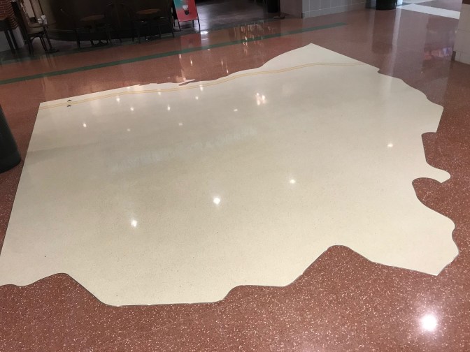 Map of Ohio on floor of rest stop.