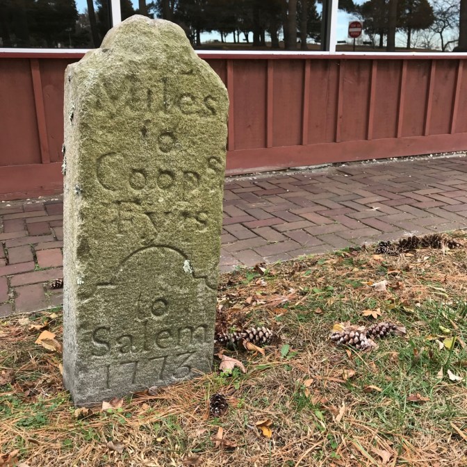 Stone mile marker says MILES TO COOPS FYES TO SALEM 1773