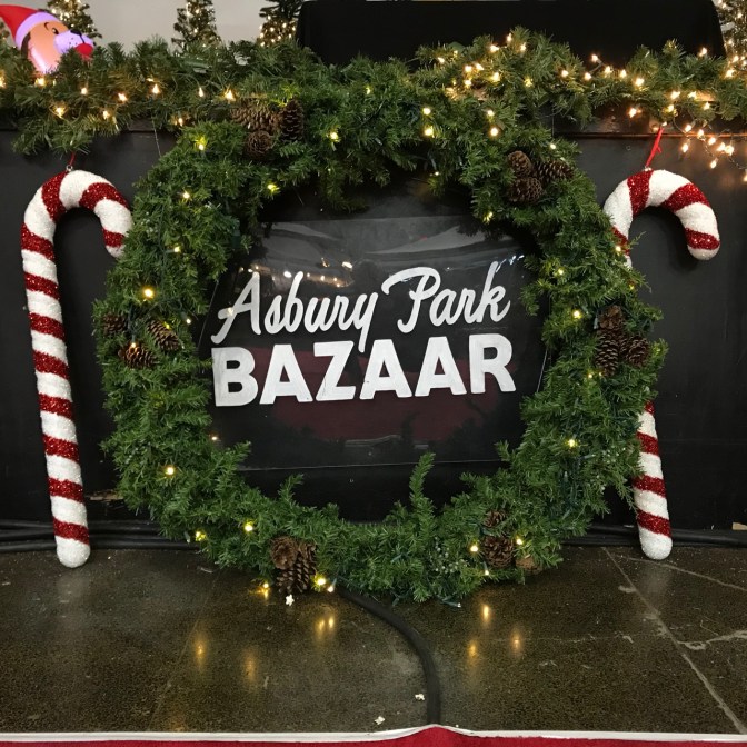 Wreath with candy canes on either side and in middle, words that say ASBURY PARK BAZAAR.