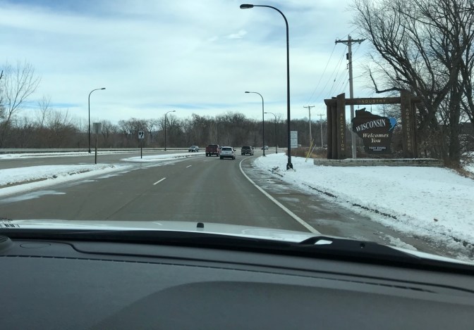 Roadside sign that says WISCONSIN WELCOMES YOU.