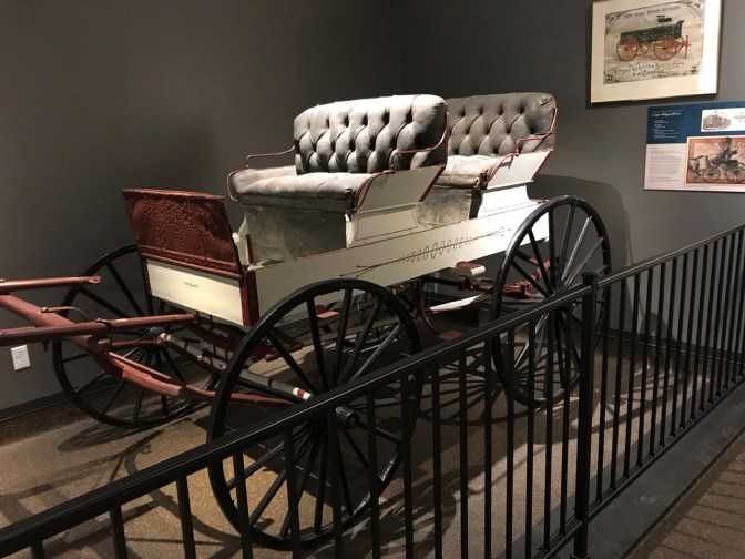 Wagon, painted white, with two rows of seats.