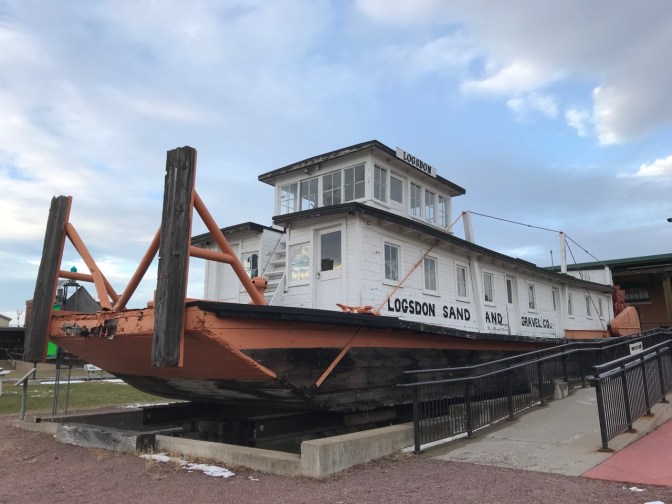 River boat in dry dock, with words on its side: LOGSDON SAND AND GRAVEL CO