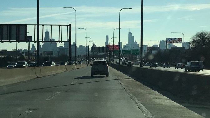 View of Chicago skyline past highway.