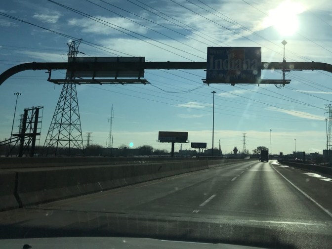 Sign above highway that says WELCOME TO INDIANA.