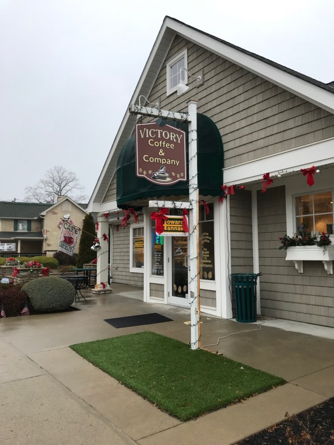 Exterior of Victory Coffee & Company, a one-store shingled building with a peaked roof.