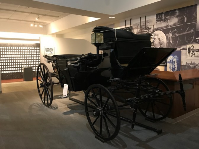 Black horse-drawn carriage.