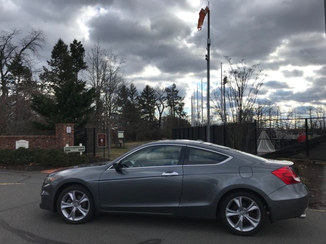 2012 Honda Accord parked in parking lot along entrance to walking path.