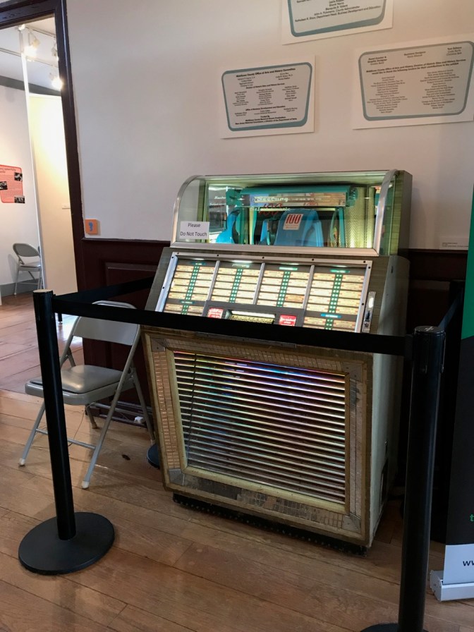 Jukebox in middle of hallway.