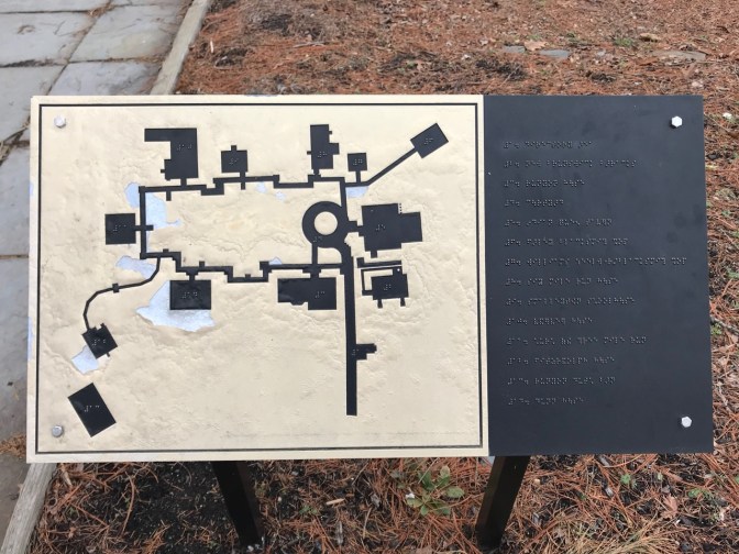 Sign with tactile map of village and braille signage.