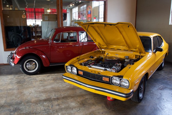 Yellow Ford Capri and red Volkswagen Beetle.
