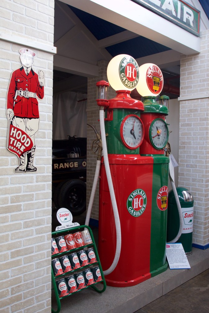 Two antique gasoline pumps, one in red, the other in green.