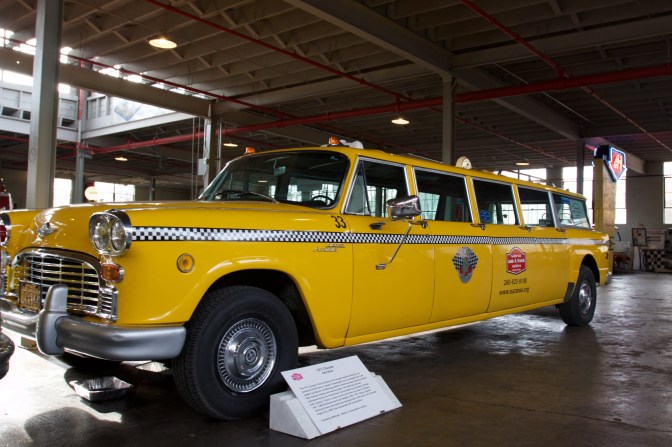 Stretched Checkers yellow taxi cab.